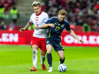 Kamil Piatkowski (L) and Stuart Armstrong during the  UEFA Nations League 2024 League A Group A1 match between Poland and Scotland, at the...