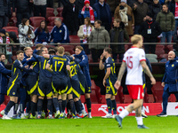 Scottish team celebrates scoring a winning goal  during the  UEFA Nations League 2024 League A Group A1 match between Poland and Scotland, a...