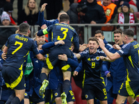 Scottish team celebrates scoring a winning goal  during the  UEFA Nations League 2024 League A Group A1 match between Poland and Scotland, a...