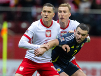 Piotr Zielinski, Adam Buksa and John McGinn in action during the  UEFA Nations League 2024 League A Group A1 match between Poland and Scotla...