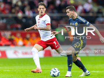 Kacper Urbanski and Kenny McLean during the  UEFA Nations League 2024 League A Group A1 match between Poland and Scotland, at the  PGE Narod...