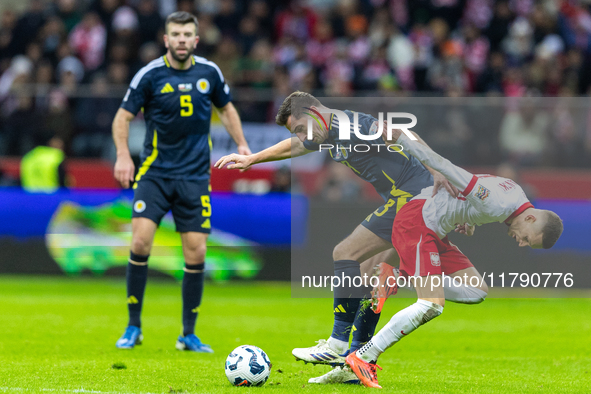 Kenny McLean and Sebastian Szymanski in action during the  UEFA Nations League 2024 League A Group A1 match between Poland and Scotland, at...