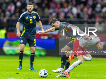 Kenny McLean and Sebastian Szymanski in action during the  UEFA Nations League 2024 League A Group A1 match between Poland and Scotland, at...