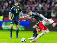 Kenny McLean and Sebastian Szymanski in action during the  UEFA Nations League 2024 League A Group A1 match between Poland and Scotland, at...