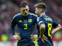 Andy Robertson and Billy Gilmour  talk during the  UEFA Nations League 2024 League A Group A1 match between Poland and Scotland, at the  PGE...