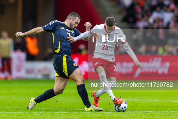 John McGinn and Sebastian Szymanski in action during the  UEFA Nations League 2024 League A Group A1 match between Poland and Scotland, at t...