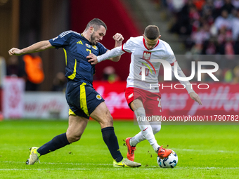 John McGinn and Sebastian Szymanski in action during the  UEFA Nations League 2024 League A Group A1 match between Poland and Scotland, at t...