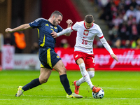 John McGinn and Sebastian Szymanski in action during the  UEFA Nations League 2024 League A Group A1 match between Poland and Scotland, at t...