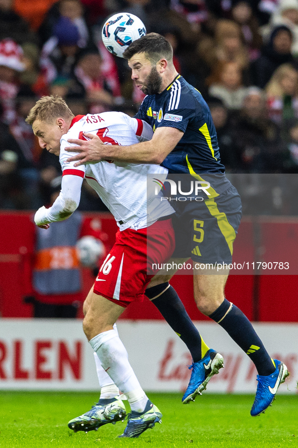 Adam Buksa and Grant Hanley in action during the  UEFA Nations League 2024 League A Group A1 match between Poland and Scotland, at the  PGE...