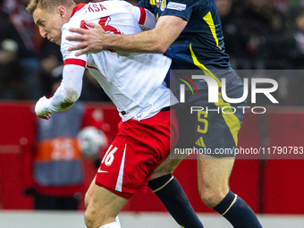 Adam Buksa and Grant Hanley in action during the  UEFA Nations League 2024 League A Group A1 match between Poland and Scotland, at the  PGE...