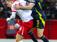 Adam Buksa and Grant Hanley in action during the  UEFA Nations League 2024 League A Group A1 match between Poland and Scotland, at the  PGE...