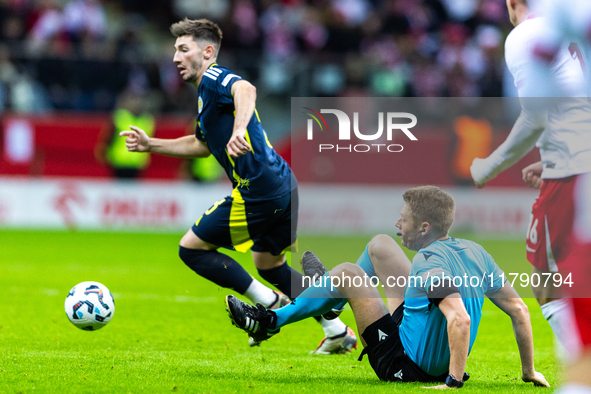 Referee Christian Dingert  falls  during the  UEFA Nations League 2024 League A Group A1 match between Poland and Scotland, at the  PGE Naro...