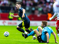 Referee Christian Dingert  falls  during the  UEFA Nations League 2024 League A Group A1 match between Poland and Scotland, at the  PGE Naro...