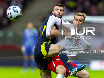 Grant Hanley and Adam Buksa in action during the  UEFA Nations League 2024 League A Group A1 match between Poland and Scotland, at the  PGE...