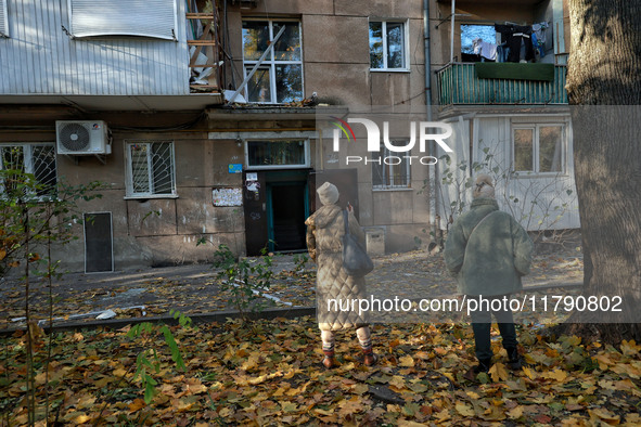 People are seen outside a residential building damaged by Russian rocket fire in Odesa, Ukraine, on November 18, 2024. NO USE RUSSIA. NO USE...