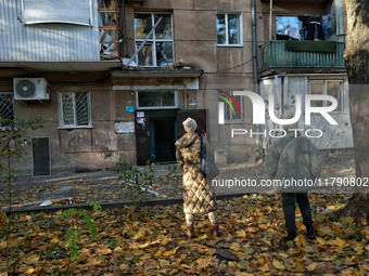 People are seen outside a residential building damaged by Russian rocket fire in Odesa, Ukraine, on November 18, 2024. NO USE RUSSIA. NO USE...