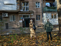 People are seen outside a residential building damaged by Russian rocket fire in Odesa, Ukraine, on November 18, 2024. NO USE RUSSIA. NO USE...