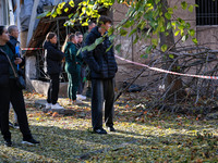 People watch the elimination of the consequences of a Russian missile strike in Odesa, Ukraine, on November 18, 2024. (