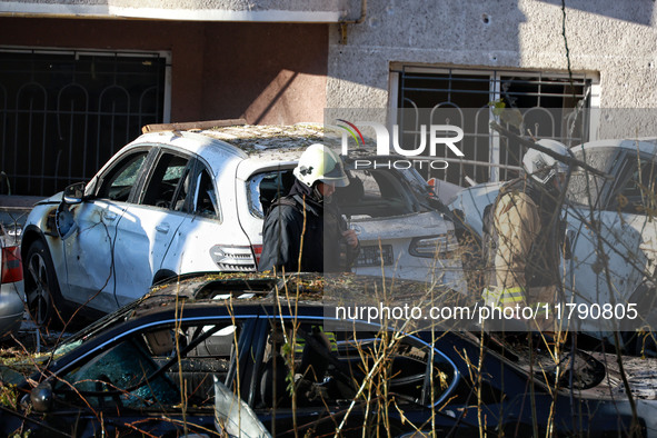 Rescuers are seen next to the cars mutilated by a Russian missile strike in Odesa, Ukraine, on November 18, 2024. NO USE RUSSIA. NO USE BELA...