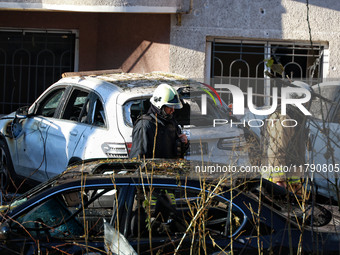 Rescuers are seen next to the cars mutilated by a Russian missile strike in Odesa, Ukraine, on November 18, 2024. NO USE RUSSIA. NO USE BELA...