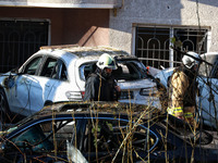 Rescuers are seen next to the cars mutilated by a Russian missile strike in Odesa, Ukraine, on November 18, 2024. NO USE RUSSIA. NO USE BELA...