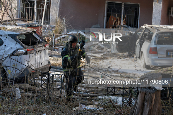 A rescuer stands next to the cars damaged by a Russian missile strike in Odesa, Ukraine, on November 18, 2024. NO USE RUSSIA. NO USE BELARUS...