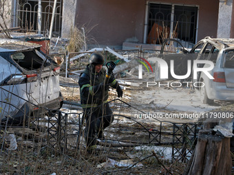 A rescuer stands next to the cars damaged by a Russian missile strike in Odesa, Ukraine, on November 18, 2024. NO USE RUSSIA. NO USE BELARUS...