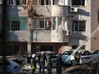 Rescuers stand next to the cars damaged by Russian rocket fire in Odesa, Ukraine, on November 18, 2024. NO USE RUSSIA. NO USE BELARUS. (