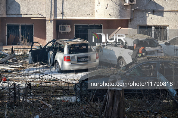 A rescuer stands next to the cars damaged by Russian rocket fire in Odesa, Ukraine, on November 18, 2024. NO USE RUSSIA. NO USE BELARUS. 