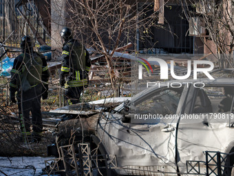 Rescuers stand next to a car mutilated by Russian rocket fire in Odesa, Ukraine, on November 18, 2024. NO USE RUSSIA. NO USE BELARUS. (