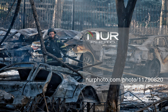 A rescuer stands next to the cars damaged by Russian rocket fire in Odesa, Ukraine, on November 18, 2024. NO USE RUSSIA. NO USE BELARUS. 