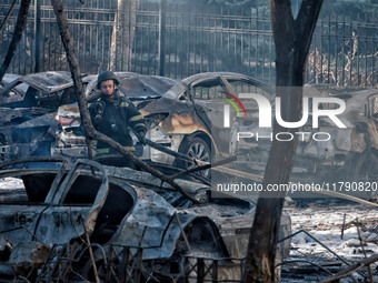 A rescuer stands next to the cars damaged by Russian rocket fire in Odesa, Ukraine, on November 18, 2024. NO USE RUSSIA. NO USE BELARUS. (