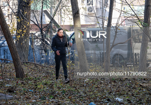 A woman stands against the background of cars damaged by Russian rocket fire in Odesa, Ukraine, on November 18, 2024. NO USE RUSSIA. NO USE...