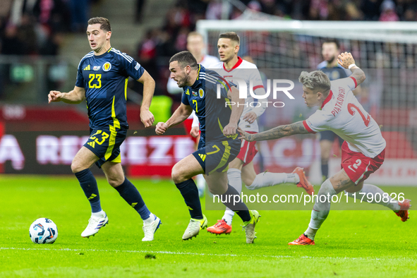 Kenny McLean, John McGinn and Kamil Piatkowski in action during the  UEFA Nations League 2024 League A Group A1 match between Poland and Sco...