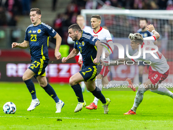 Kenny McLean, John McGinn and Kamil Piatkowski in action during the  UEFA Nations League 2024 League A Group A1 match between Poland and Sco...