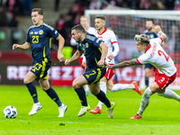 Kenny McLean, John McGinn and Kamil Piatkowski in action during the  UEFA Nations League 2024 League A Group A1 match between Poland and Sco...