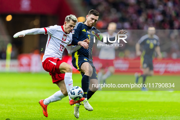 Jakub Kaminski and Andy Robertson during the  UEFA Nations League 2024 League A Group A1 match between Poland and Scotland, at the  PGE Naro...