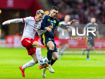 Jakub Kaminski and Andy Robertson during the  UEFA Nations League 2024 League A Group A1 match between Poland and Scotland, at the  PGE Naro...