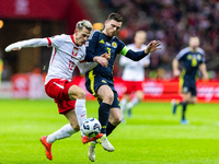 Jakub Kaminski and Andy Robertson during the  UEFA Nations League 2024 League A Group A1 match between Poland and Scotland, at the  PGE Naro...