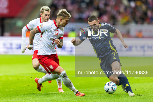 Kamil Piatkowski, and John McGinn in action during the  UEFA Nations League 2024 League A Group A1 match between Poland and Scotland, at the...