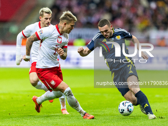 Kamil Piatkowski, and John McGinn in action during the  UEFA Nations League 2024 League A Group A1 match between Poland and Scotland, at the...