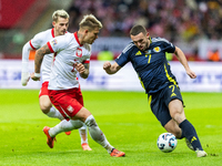 Kamil Piatkowski, and John McGinn in action during the  UEFA Nations League 2024 League A Group A1 match between Poland and Scotland, at the...