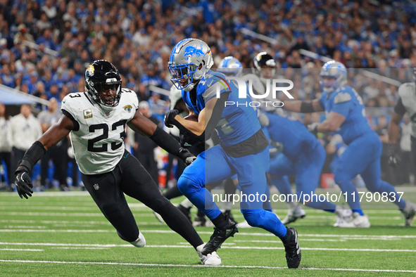 DETROIT,MICHIGAN-November 17: Detroit Lions wide receiver Amon-Ra St. Brown (14) carries the ball during the first half of an NFL football g...