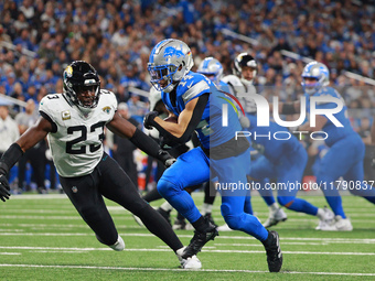 DETROIT,MICHIGAN-November 17: Detroit Lions wide receiver Amon-Ra St. Brown (14) carries the ball during the first half of an NFL football g...