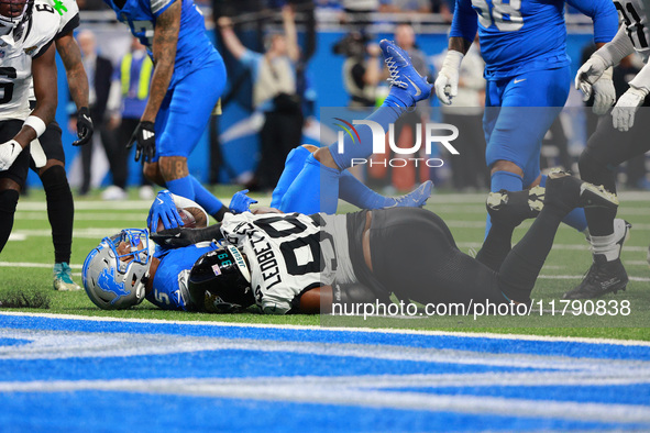 DETROIT,MICHIGAN-November 17: Detroit Lions running back David Montgomery (5) is tackled by Jacksonville Jaguars defensive tackle Jeremiah L...