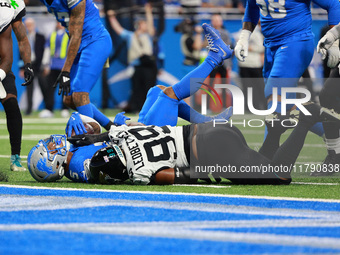 DETROIT,MICHIGAN-November 17: Detroit Lions running back David Montgomery (5) is tackled by Jacksonville Jaguars defensive tackle Jeremiah L...