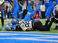 DETROIT,MICHIGAN-November 17: Detroit Lions running back David Montgomery (5) is tackled by Jacksonville Jaguars defensive tackle Jeremiah L...