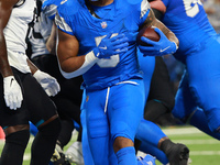 DETROIT,MICHIGAN-November 17: Detroit Lions running back David Montgomery (5) scores a touchdown during the first half of an NFL football ga...