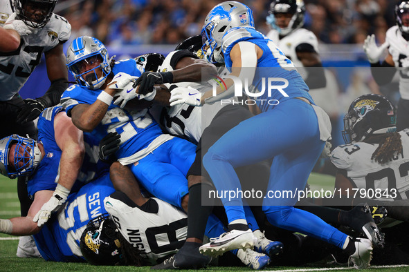 DETROIT,MICHIGAN-November 17: Detroit Lions running back Jahmyr Gibbs (26) is tackled during the second half of an NFL football game between...