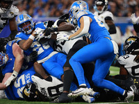 DETROIT,MICHIGAN-November 17: Detroit Lions running back Jahmyr Gibbs (26) is tackled during the second half of an NFL football game between...